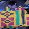 Heavy-duty cotton-rich Kente printed textile blend, natural polished wood handles.