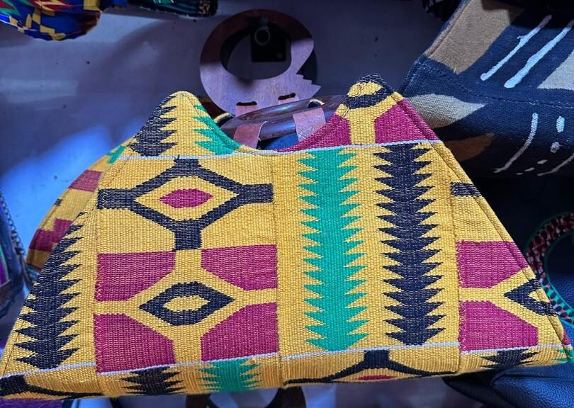 Heavy-duty cotton-rich Kente printed textile blend, natural polished wood handles.